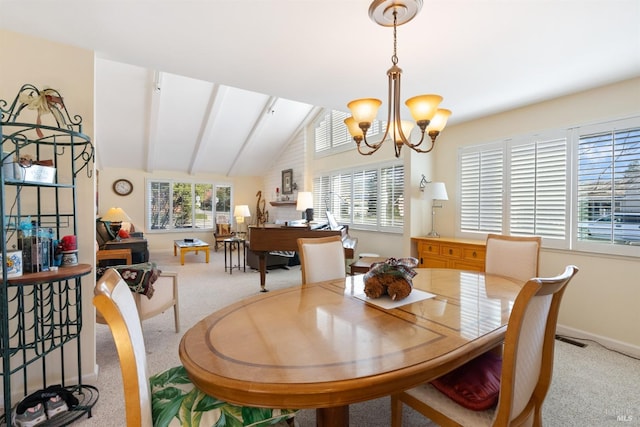 carpeted dining room featuring a wealth of natural light, lofted ceiling with beams, and a notable chandelier