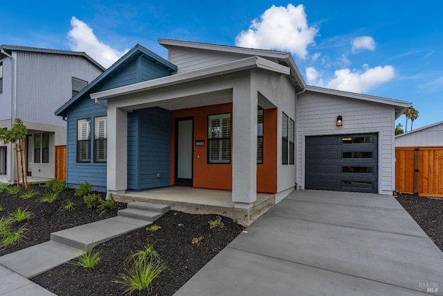 contemporary house featuring a porch and a garage