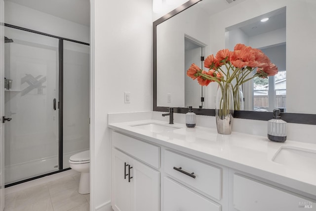 bathroom featuring tile patterned floors, vanity, toilet, and an enclosed shower