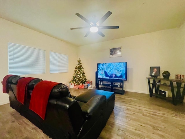 living room featuring ceiling fan and light wood-type flooring