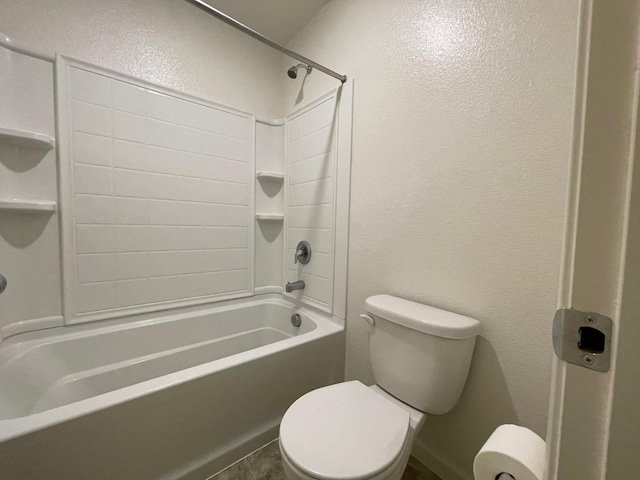 bathroom featuring shower / bathing tub combination and toilet