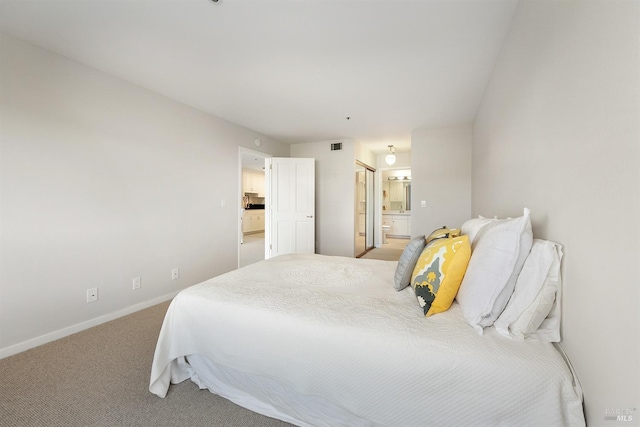 carpeted bedroom featuring connected bathroom