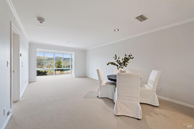 dining area with carpet and ornamental molding