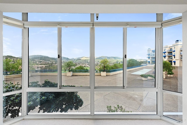 unfurnished sunroom with a mountain view