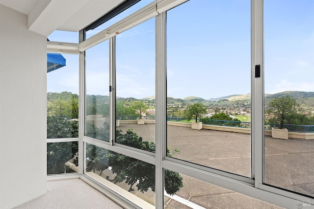 unfurnished sunroom featuring a mountain view