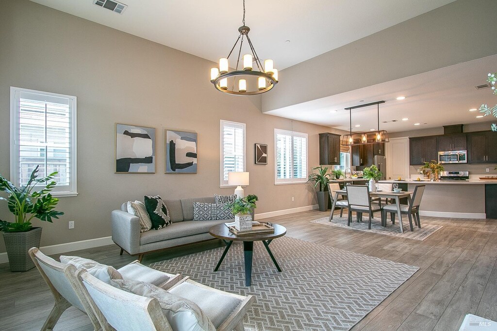 3132 Muse Way, Fairfield, CA 94533 - living room featuring light wood-type flooring, baseboards, a chandelier, recessed lighting, and visible vents
