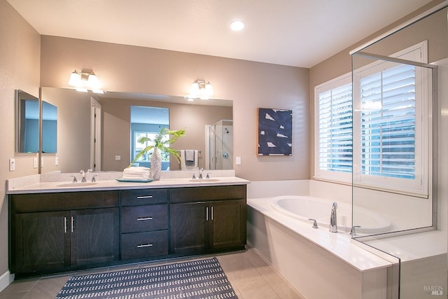 bathroom featuring tile patterned flooring, vanity, and separate shower and tub