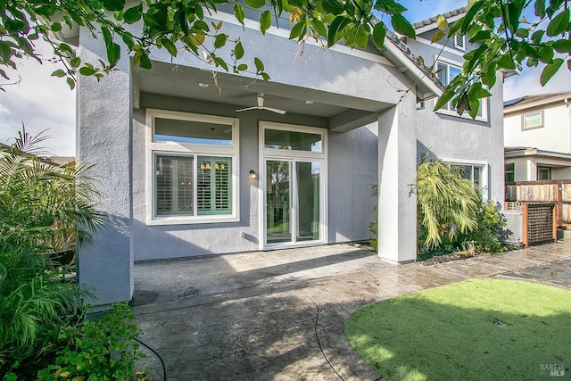 property entrance featuring a patio area and ceiling fan