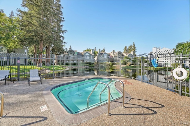 view of pool with a water view