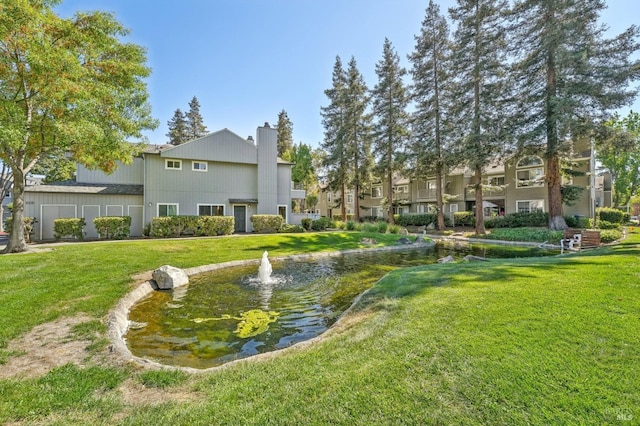 view of property's community with a lawn