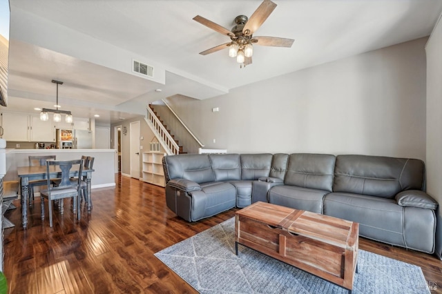 living room featuring dark hardwood / wood-style flooring and ceiling fan