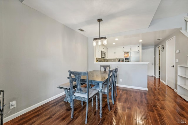 dining area with dark hardwood / wood-style flooring