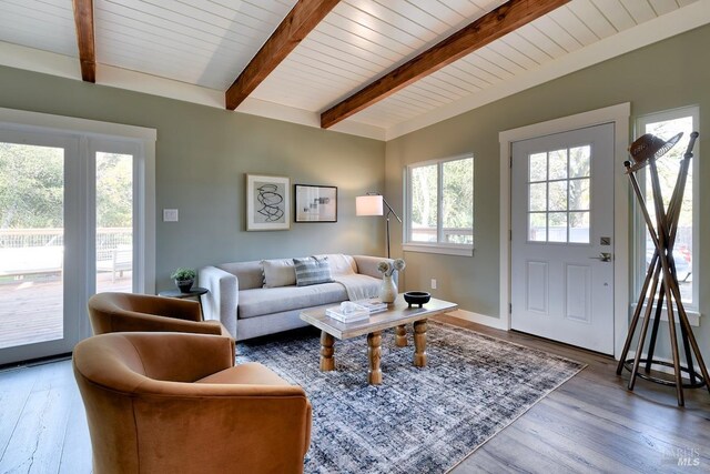 living room with french doors, beamed ceiling, dark wood-type flooring, and wooden ceiling