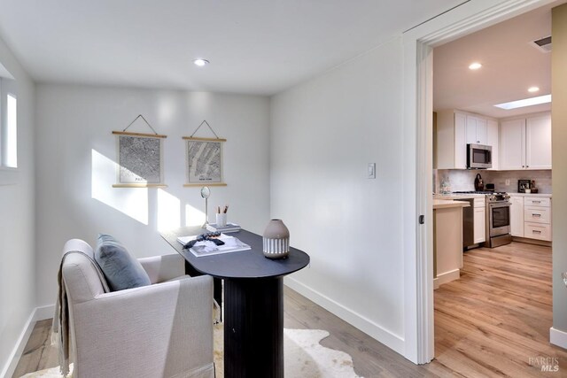 bedroom with french doors and light hardwood / wood-style flooring