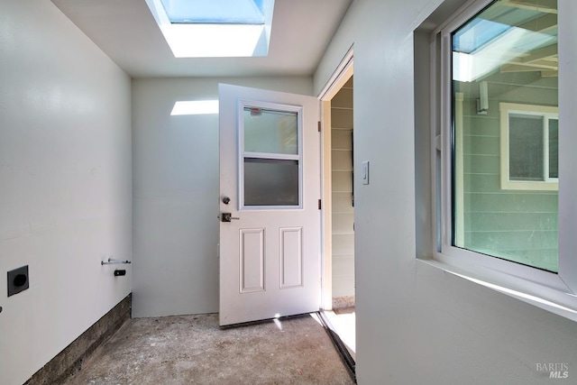 clothes washing area featuring laundry area, a skylight, a wealth of natural light, and hookup for an electric dryer