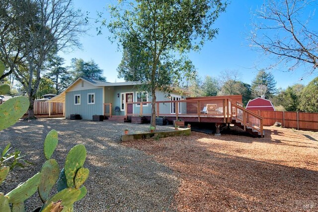 back of house featuring french doors and a deck