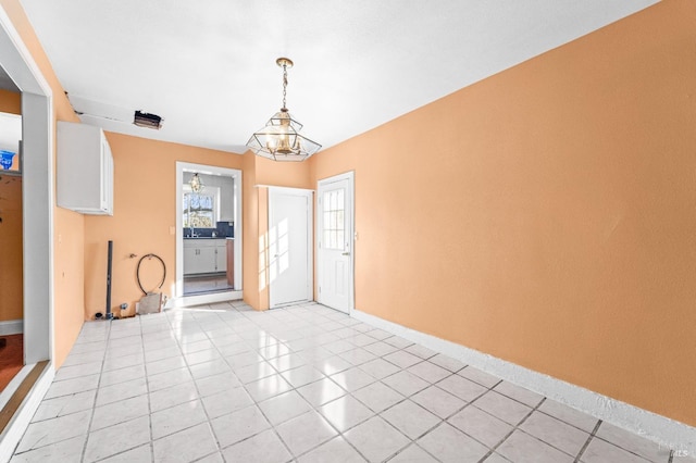 tiled foyer featuring a notable chandelier