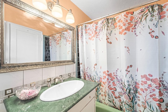 bathroom with backsplash, vanity, and tile walls