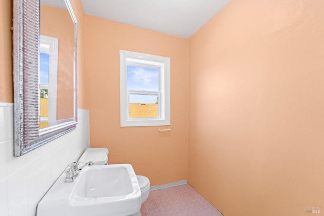 half bathroom featuring tile patterned floors and a sink