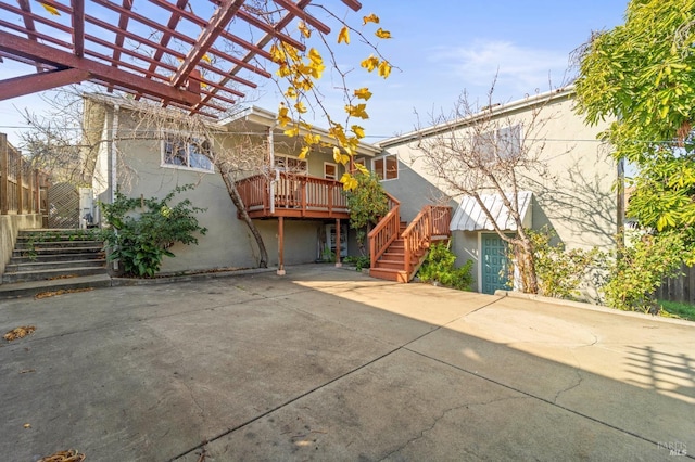 view of front of house with a pergola and a wooden deck