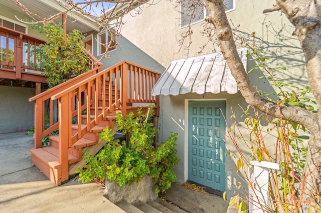 view of exterior entry featuring a wooden deck