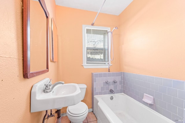 full bathroom featuring shower / washtub combination, sink, tile patterned flooring, and toilet