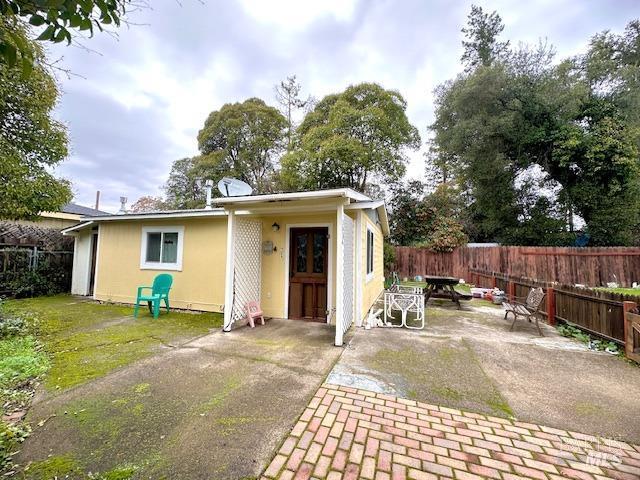 back of house with a yard and a patio area