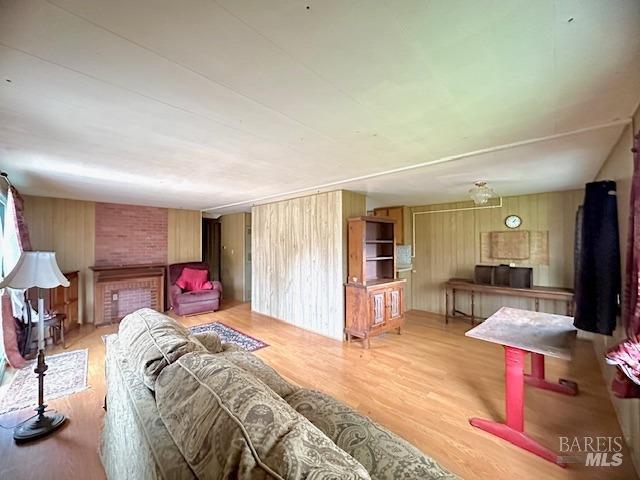 living room featuring wood walls and light wood-type flooring