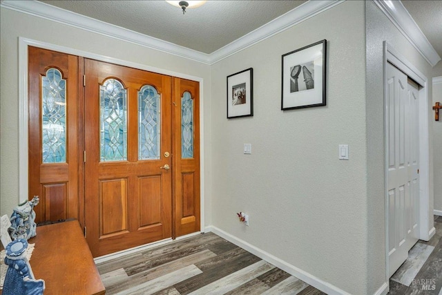 foyer featuring hardwood / wood-style flooring, crown molding, and a textured ceiling