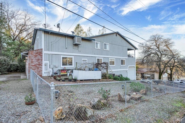 rear view of property featuring a wall mounted AC