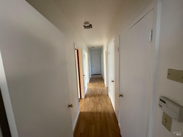 hall with hardwood / wood-style floors