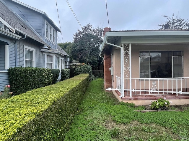 view of side of property with a porch