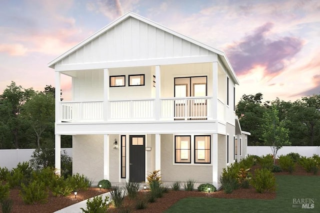 view of front of house with a porch and a balcony