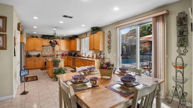 tiled dining room featuring sink