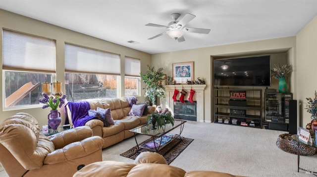 carpeted living room with ceiling fan