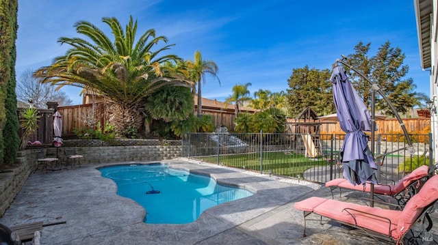 view of pool with a lawn and a patio area