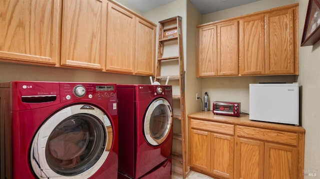 laundry room with cabinets and washing machine and clothes dryer