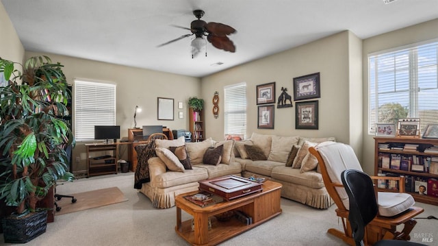 living room with ceiling fan and a healthy amount of sunlight