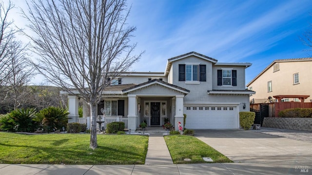 view of front of house with fence, an attached garage, stucco siding, concrete driveway, and a front lawn