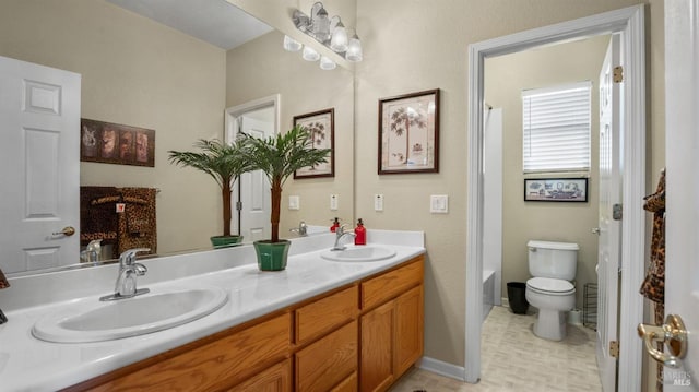 bathroom with vanity, a bath, and toilet