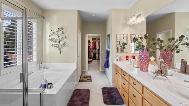 bathroom featuring vanity and independent shower and bath