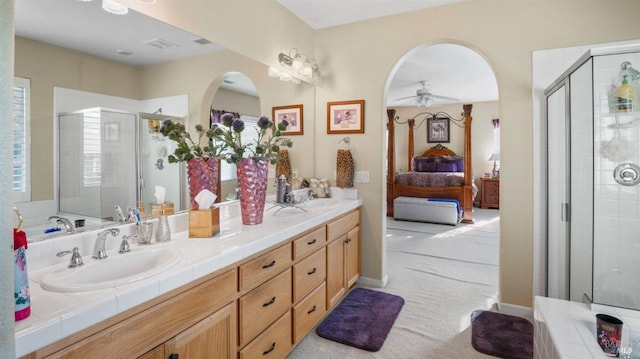 bathroom with ceiling fan, vanity, and a shower with shower door