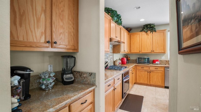 kitchen with light stone counters and stainless steel appliances