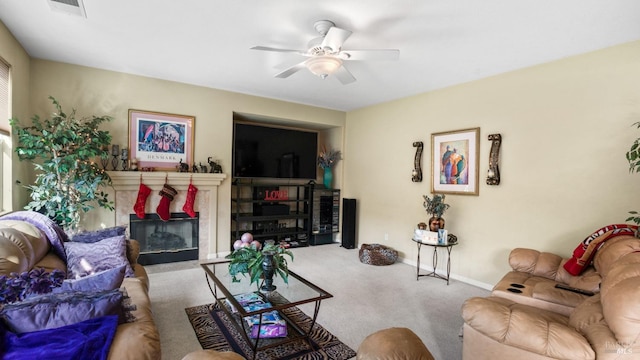 living room with ceiling fan, a fireplace, and carpet