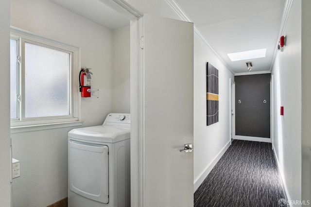 washroom featuring washer / dryer, a skylight, crown molding, and dark hardwood / wood-style floors