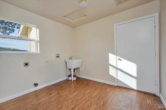 laundry room featuring washer hookup, light wood-type flooring, and electric dryer hookup