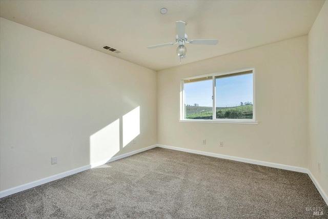 carpeted spare room with ceiling fan