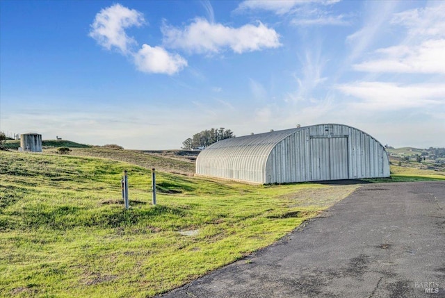 view of outbuilding with a rural view