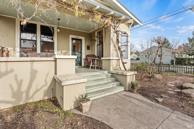 entrance to property featuring covered porch