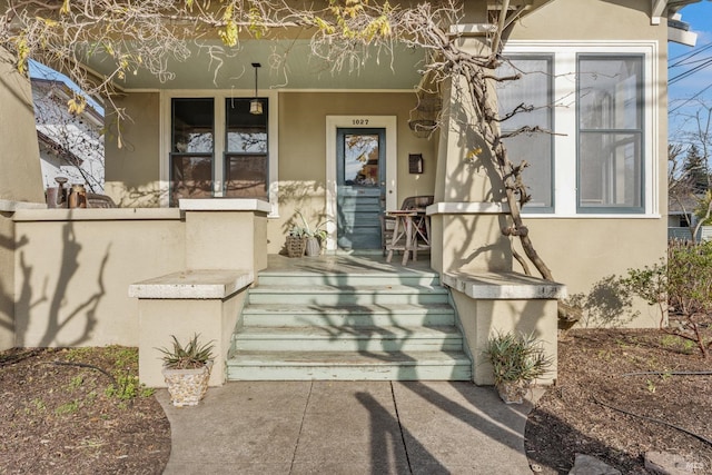 view of exterior entry featuring a porch